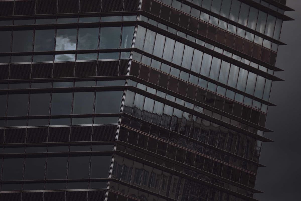 High-rise glass facade panels up close Close view of the angled glass window panels on a high-rise building facade