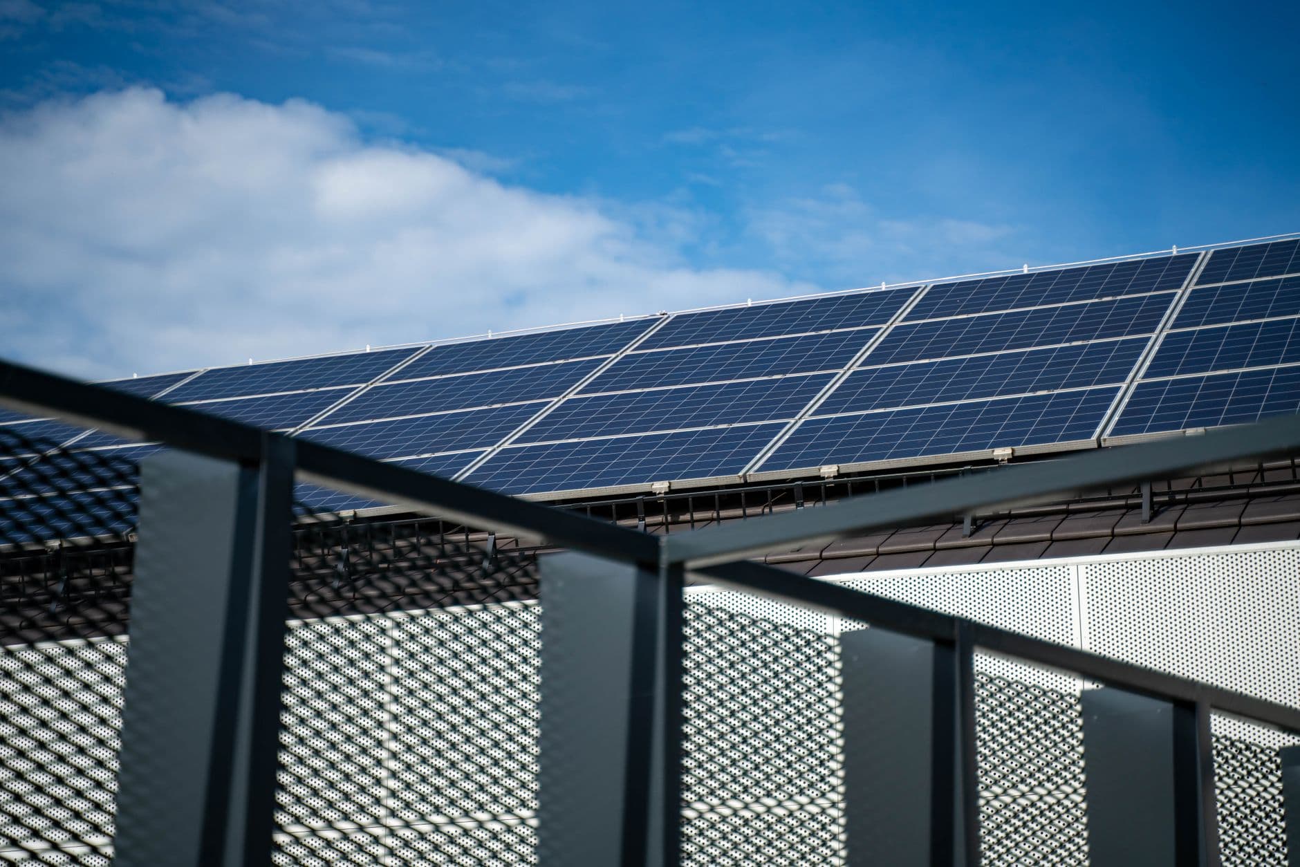 Commercial rooftop solar array Rows of solar panels mounted on a commercial building rooftop